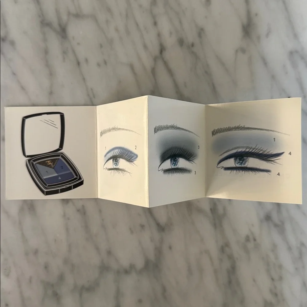 Chanel black logo matte paper gift bag + bonus eye makeup instruction booklet.